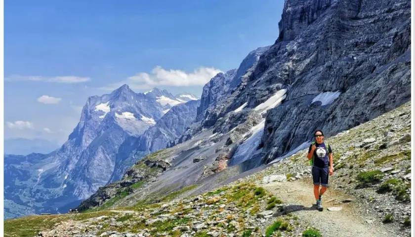 Wędrowiec na szlaku w Alpach. Widok zapiera dech w piersiach, idealne miejsce, by zobaczyć, co oferuje Szwajcaria.