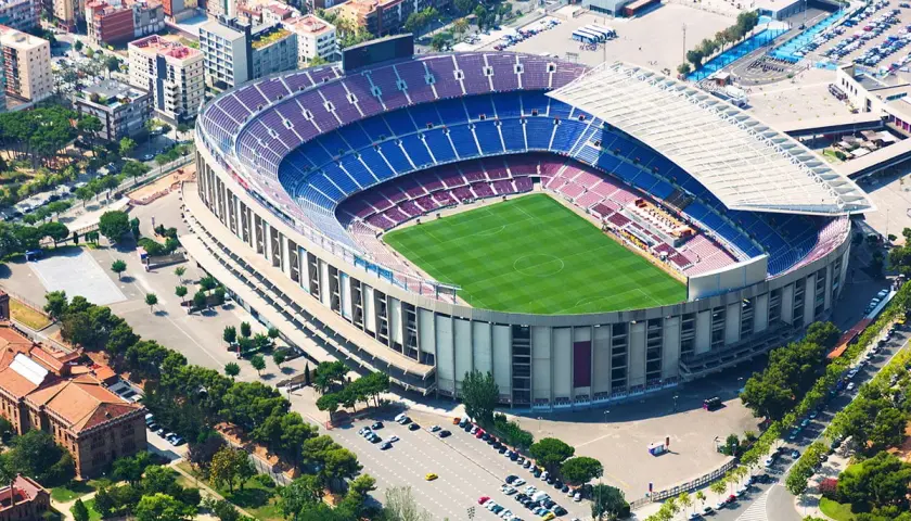 Camp Nou zwiedzanie: imponujący stadion FC Barcelona z lotu ptaka, zielona murawa i niebiesko-bordowe trybuny.